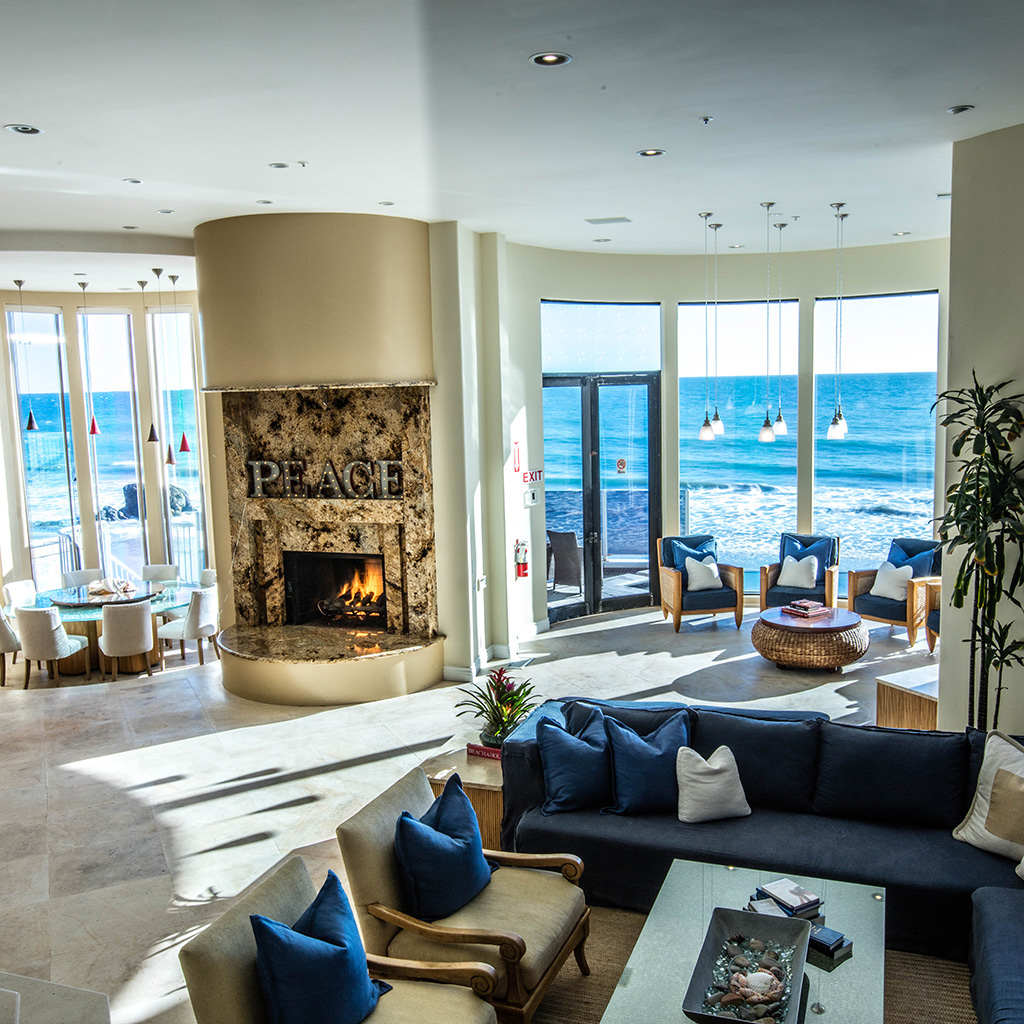 Beach House Treatment Malibu overview of living room and multiple sitting areas.