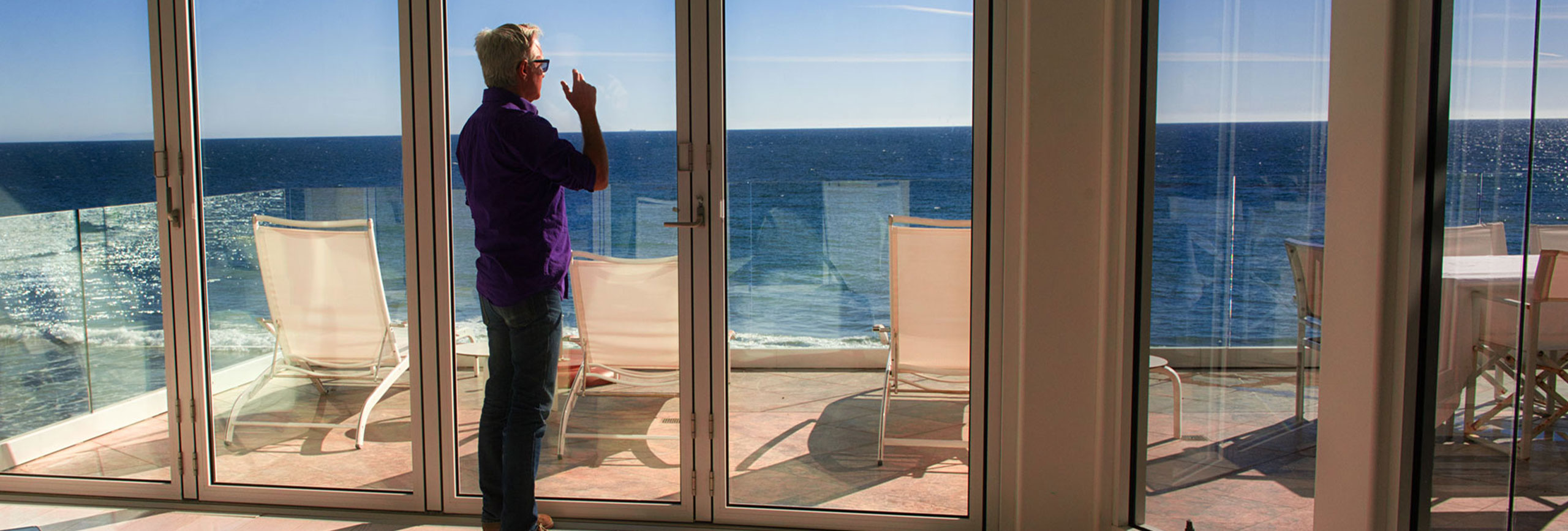Alcohol rehab patient looking at the ocean out the window of The Pointe Malibu Recovery Center.