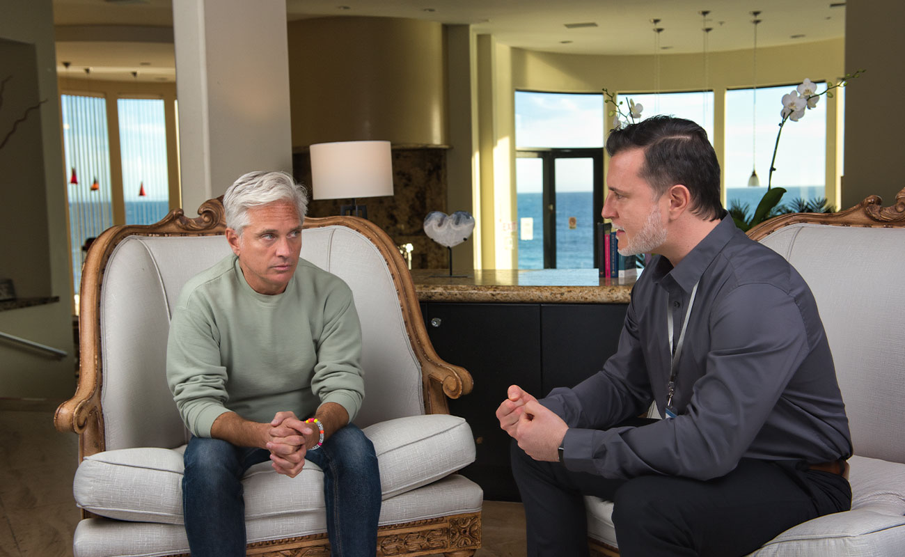 quality-treatment-proven-science Rehab client at The Point Malibu Recovery Center talking to psychiatrist.