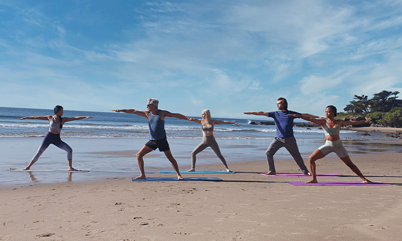 Group yoga for rehab clients by the beach in Malibu, California.