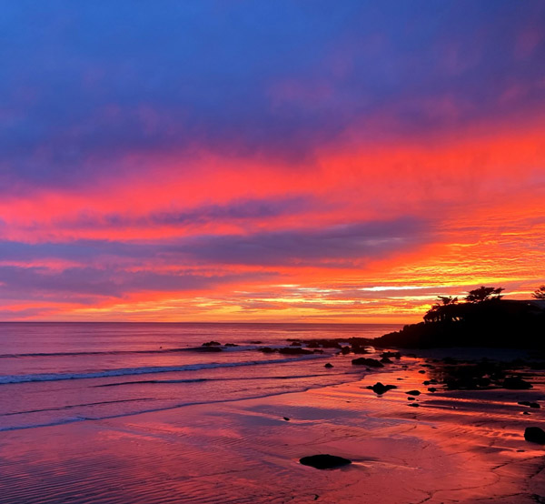 Sunset or sunrise sky clouds over sea sunlight on a beach. Amazing nature landscape seascape.